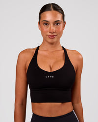 Woman wearing Stellar Long Line Sports Bra - Black-White | Model:Charli | Size:XS | Thumbnail Index: 0