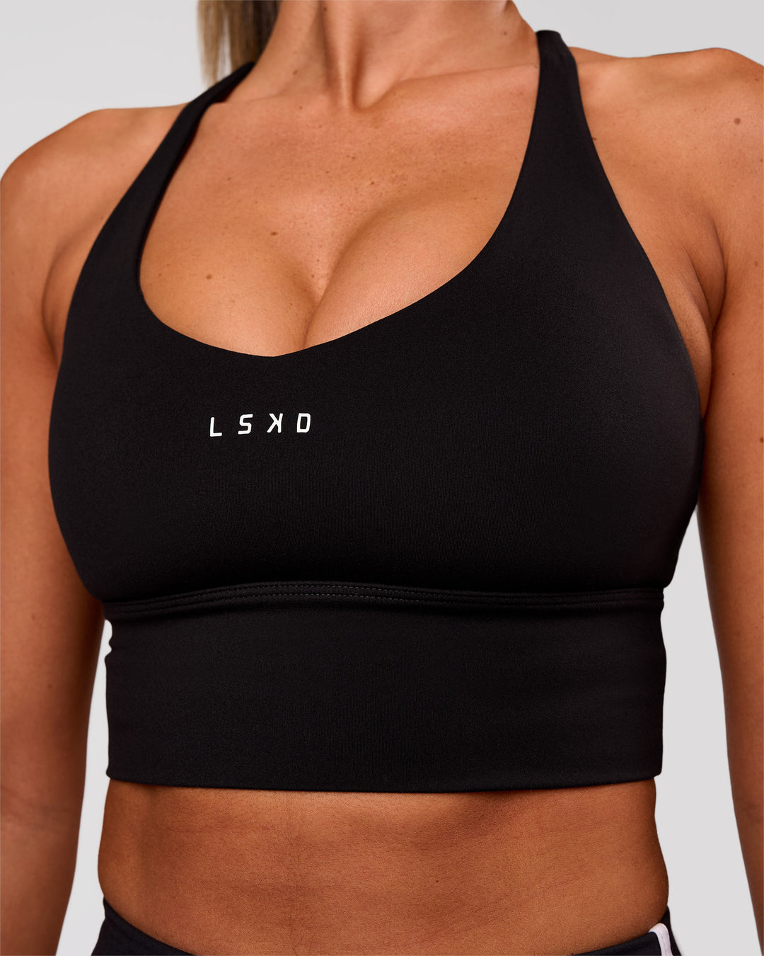 Woman wearing Stellar Long Line Sports Bra - Black-White | Model:Charli | Size:XS - view 3