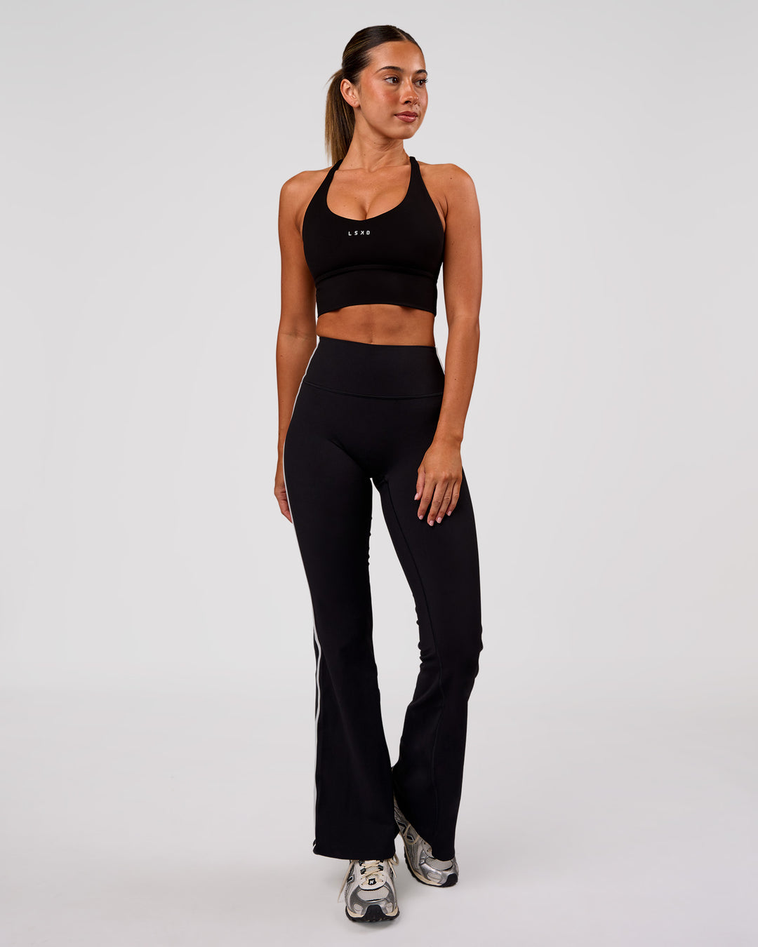 Woman wearing Stellar Long Line Sports Bra - Black-White | Model:Charli | Size:XS - view 4