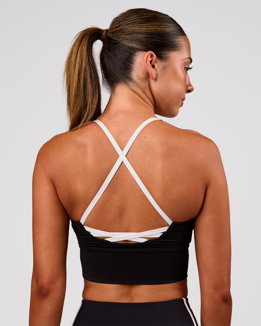 Woman wearing Stellar Long Line Sports Bra - Black-White | Model:Charli | Size:XS - view 7