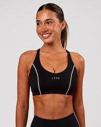 Woman wearing Stellar Sports Bra - Black-White | Model:Charli | Size:XS | Thumbnail Index: 1
