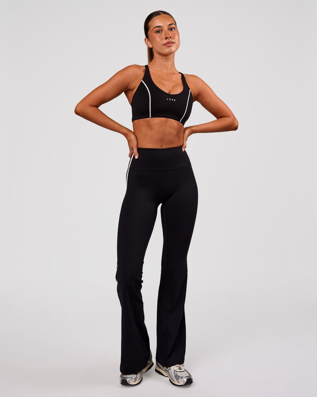 Woman wearing Stellar Sports Bra - Black-White | Model:Charli | Size:XS - view 3