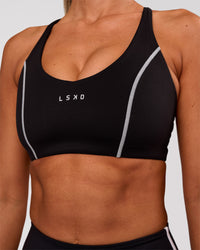 Woman wearing Stellar Sports Bra - Black-White | Model:Charli | Size:XS | Thumbnail Index: 4