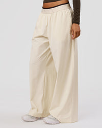 Woman wearing Stride Wide Leg Pant - Vanilla Bean | Model:Charli | Size:XS | Thumbnail Index: 1