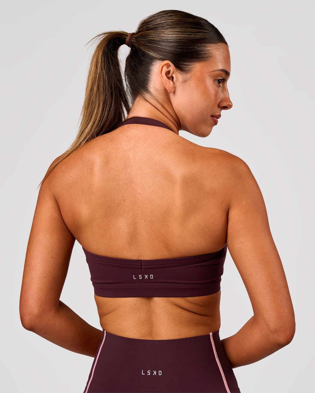 Woman wearing Unleash Sports Bra - Cherry Lacquer | Model:Charli | Size:XS - view 2