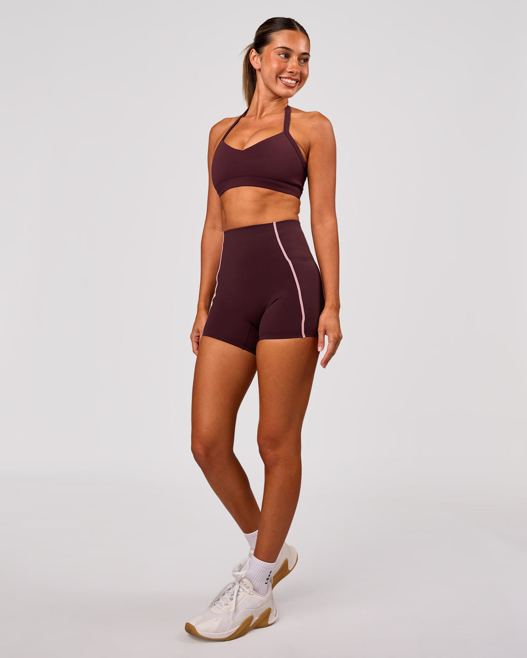 Woman wearing Unleash Sports Bra - Cherry Lacquer | Model:Charli | Size:XS - view 5