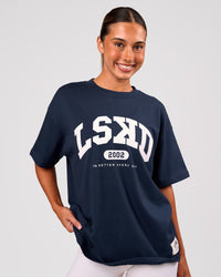 Woman wearing Varsity EST Heavyweight Oversized Tee  - Future Navy-White | Model:Charli | Size:XS | Thumbnail Index: 2