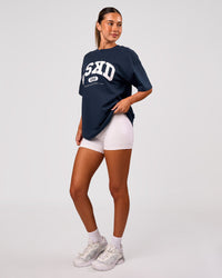 Woman wearing Varsity EST Heavyweight Oversized Tee  - Future Navy-White | Model:Charli | Size:XS | Thumbnail Index: 4