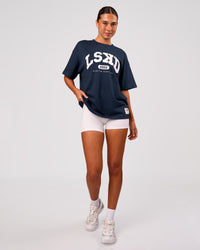 Woman wearing Varsity EST Heavyweight Oversized Tee  - Future Navy-White | Model:Charli | Size:XS | Thumbnail Index: 5