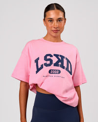 Woman wearing Varsity EST Heavyweight Oversized Tee  - Pink Rose-Future Navy | Model:Charli | Size:XS | Thumbnail Index: 2