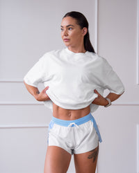 Woman wearing Accelerate 3" Mid-Rise Running Short - Open Air-White | Model:Charlotte | Size:XS | Thumbnail Index: 11