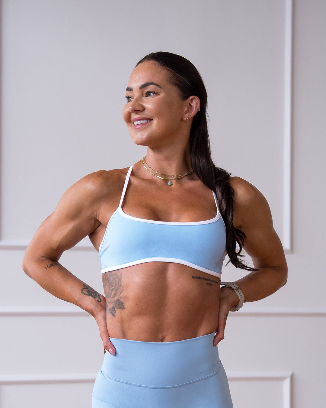 Woman wearing Strong is Beautiful Sports Bra - Open Air-White | Model:Charlotte | Size:XS - view 1