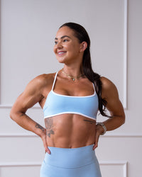 Woman wearing Strong is Beautiful Sports Bra - Open Air-White | Model:Charlotte | Size:XS | Thumbnail Index: 0