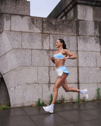 Woman wearing Strong is Beautiful Sports Bra - Open Air-White | Model:Charlotte | Size:XS | Thumbnail Index: 18