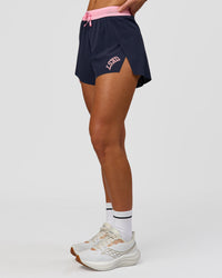 Woman wearing Accelerate 3" High-Rise Running Short - Future Navy-Varsity print | Model:Issy | Size:XS | Thumbnail Index: 4