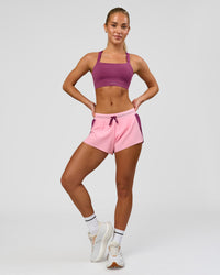 Woman wearing Accelerate 3" Mid-Rise Running Short - Boysenberry-Pink Rose | Model:Issy | Size:XS | Thumbnail Index: 2