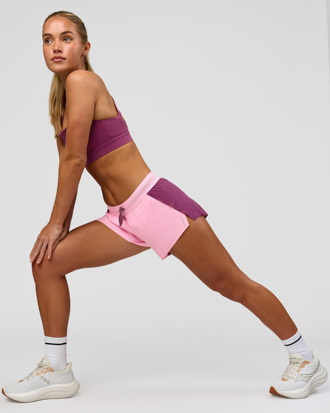 Woman wearing Accelerate 3" Mid-Rise Running Short - Boysenberry-Pink Rose | Model:Issy | Size:XS - view 6