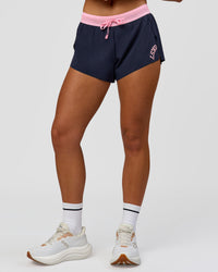 Woman wearing Accelerate 3" Mid-Rise Running Short - Future Navy-Varsity Print | Model:Issy | Size:XS | Thumbnail Index: 13
