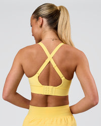 Woman wearing Accelerate Sports Bra - Lemon | Model:Issy | Size:XS | Thumbnail Index: 1