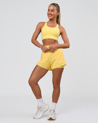 Woman wearing Accelerate Sports Bra - Lemon | Model:Issy | Size:XS | Thumbnail Index: 4