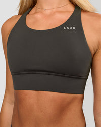 Woman wearing Accelerate Sports Bra - Onyx | Model:Issy | Size:XS | Thumbnail Index: 0