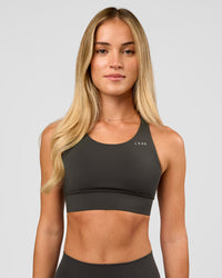 Woman wearing Accelerate Sports Bra - Onyx | Model:Issy | Size:XS | Thumbnail Index: 4