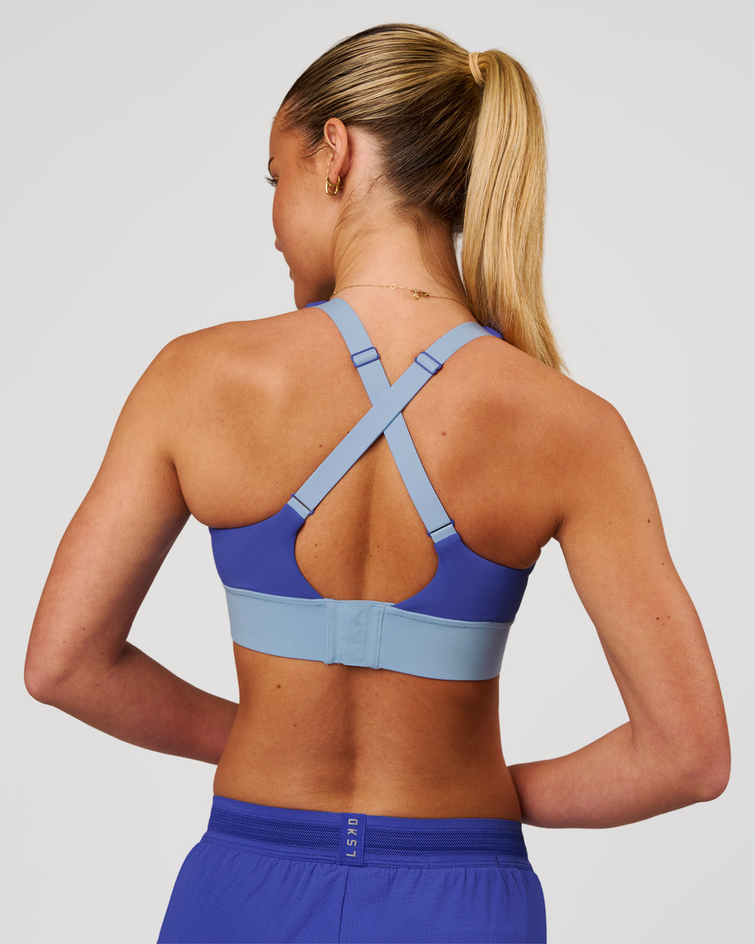 Woman wearing Accelerate Sports Bra - Power Cobalt-Open Air | Model:Issy | Size:XS - view 3