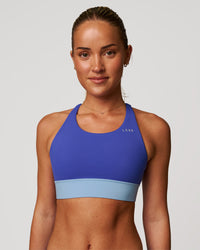 Woman wearing Accelerate Sports Bra - Power Cobalt-Open Air | Model:Issy | Size:XS | Thumbnail Index: 5