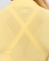 Woman wearing AeroFLX+ Long Sleeve Half Zip - Lemon/Lemon | Model:Issy | Size:XS | Thumbnail Index: 3