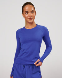 Woman wearing Aeroflx+ Seamless Long Sleeve Tee in Power Cobalt | Model: Issy | Size: XS | Thumbnail Index: 1