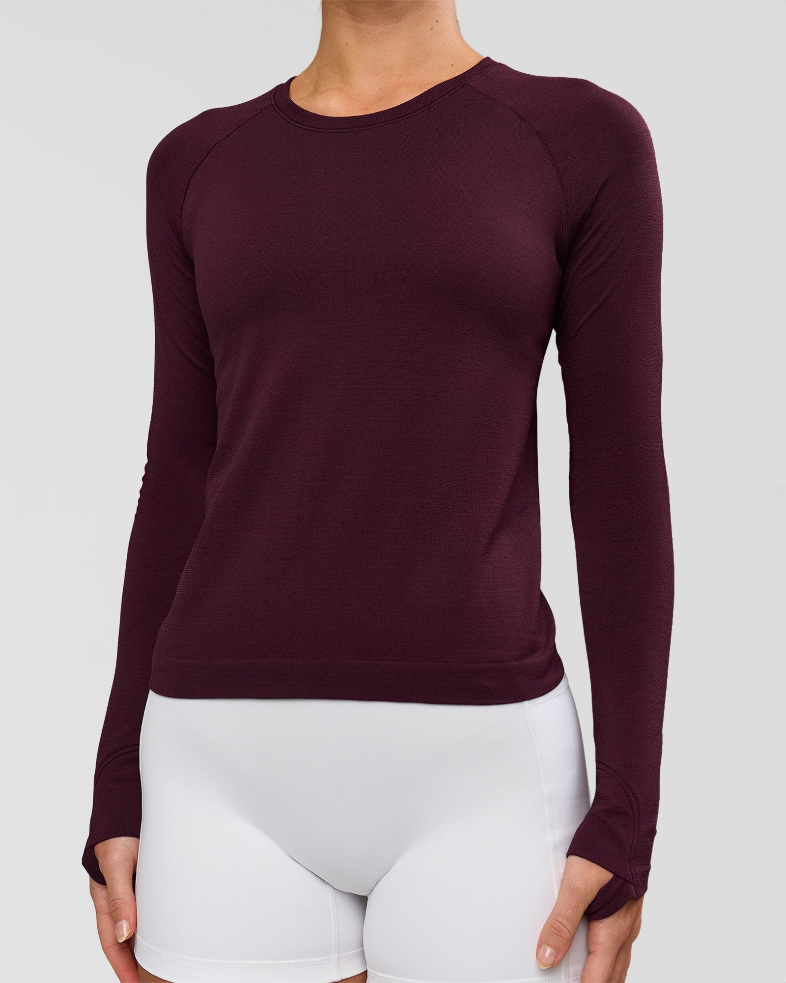 Woman wearing AeroFLX+ Seamless Long Sleeve Tee - Cherry Lacquer/Cherry Lacquer | Model:Issy | Size:XS
