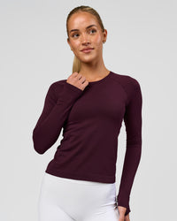 Woman wearing AeroFLX+ Seamless Long Sleeve Tee - Cherry Lacquer/Cherry Lacquer | Model:Issy | Size:XS | Thumbnail Index: 0