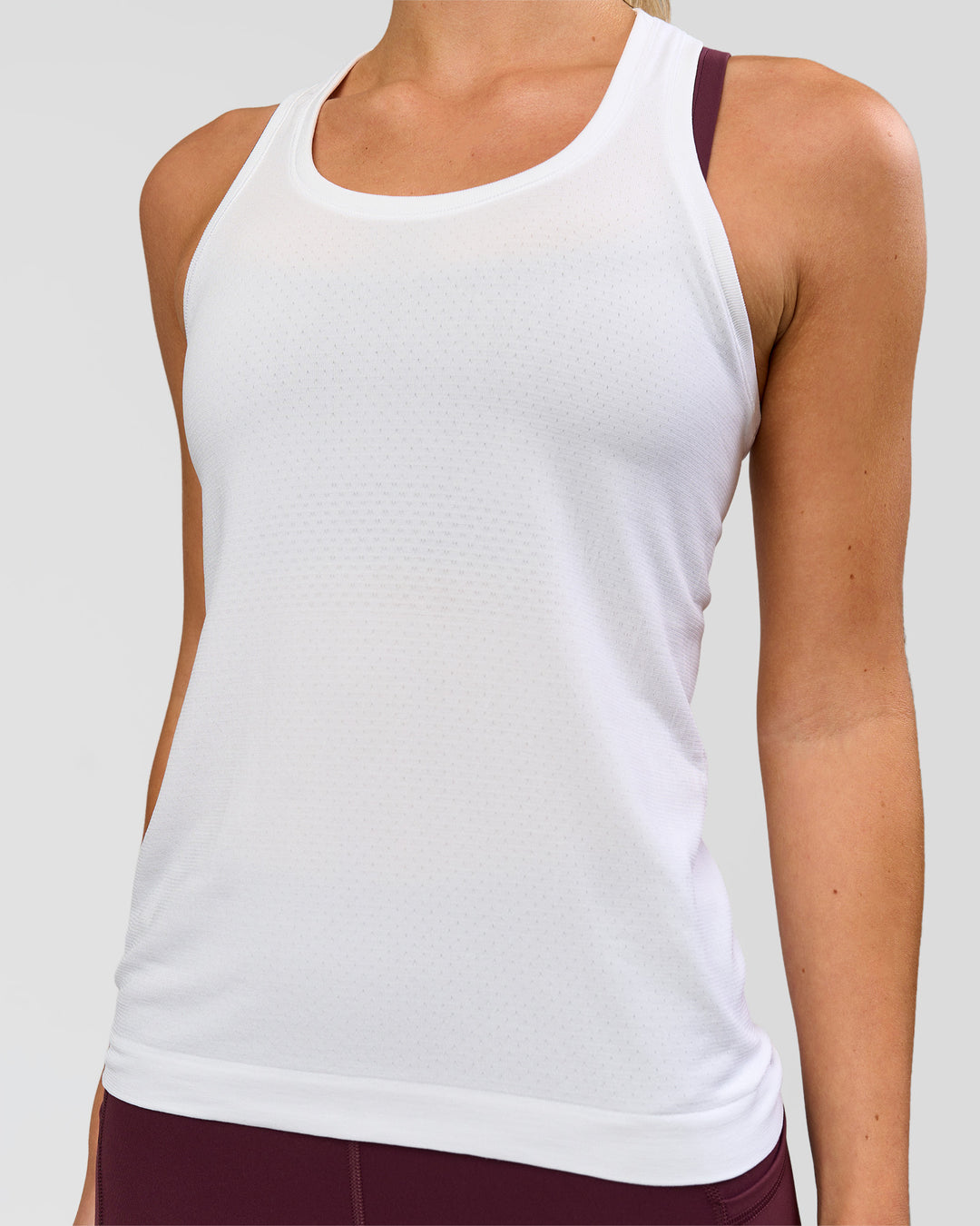 Woman wearing AeroFLX+ Seamless Tank - White/White | Model:Issy | Size:XS - view 3