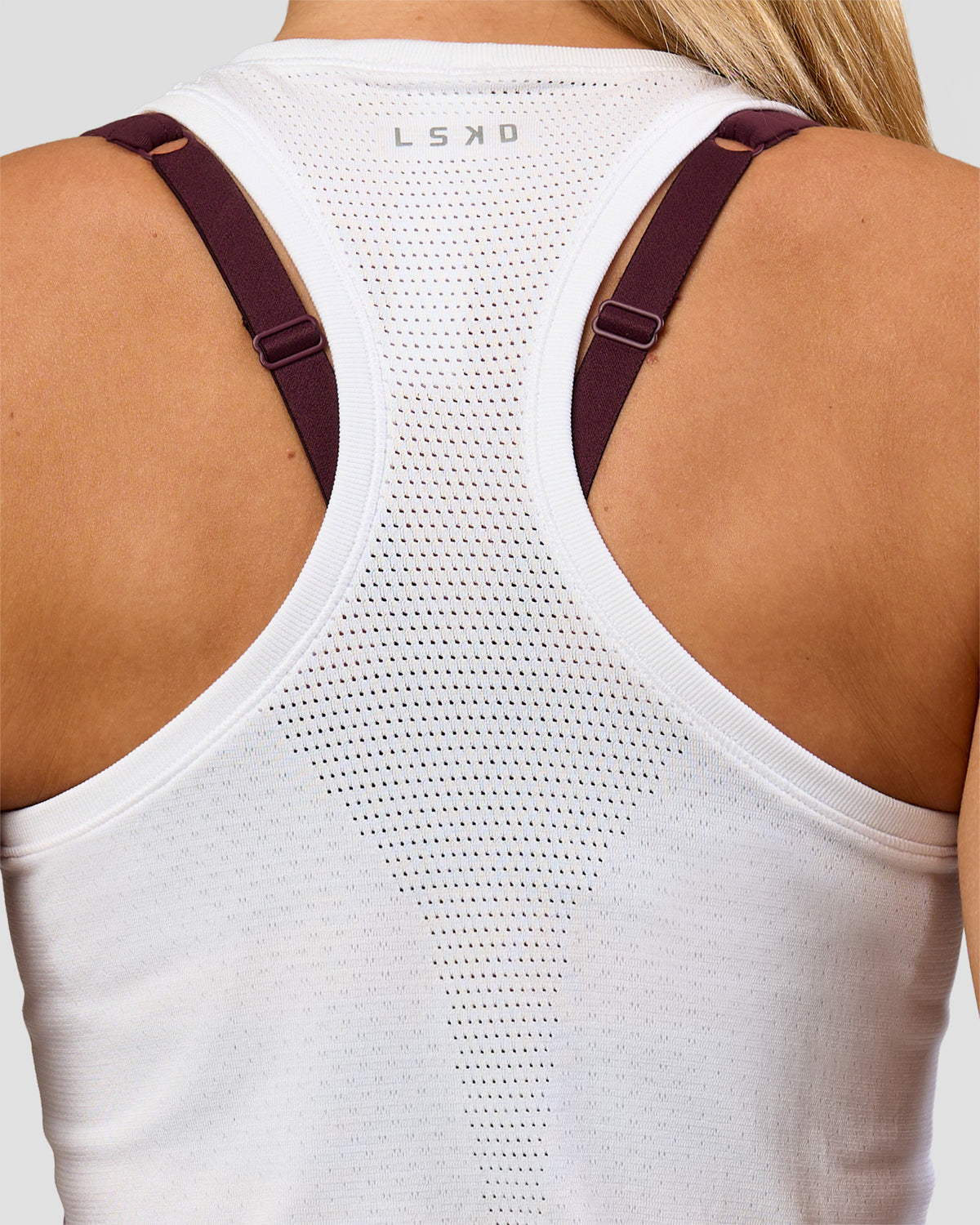 Woman wearing AeroFLX+ Seamless Tank - White/White | Model:Issy | Size:XS