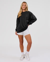 Woman wearing Backline Washed Heavyweight Oversized LS Tee - Black Washed | Model:Issy | Size:XS | Thumbnail Index: 9