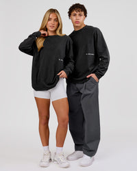 Woman wearing Backline Washed Heavyweight Oversized LS Tee - Black Washed | Model:Issy | Size:XS | Thumbnail Index: 15