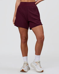 Woman wearing Challenger 5" Lined Performance Short - Cherry Lacquer | Model:Issy | Size:XS | Thumbnail Index: 1