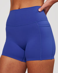 Woman wearing Elixir High-Rise 4" Short Pockets - Power Cobalt | Model:Issy | Size:XS | Thumbnail Index: 0