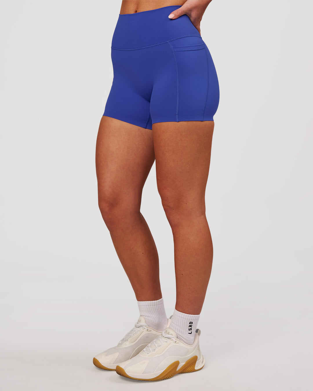 Woman wearing Elixir High-Rise 4" Short Pockets - Power Cobalt | Model:Issy | Size:XS - view 6