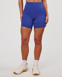 Woman wearing Elixir High-Rise 6" Short Pockets - Power Cobalt | Model:Issy | Size:XS | Thumbnail Index: 1
