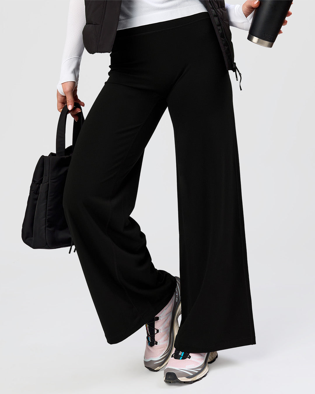 Woman wearing Elixir High-Rise Petite Pant - Black | Model:Issy | Size:XS - view 8