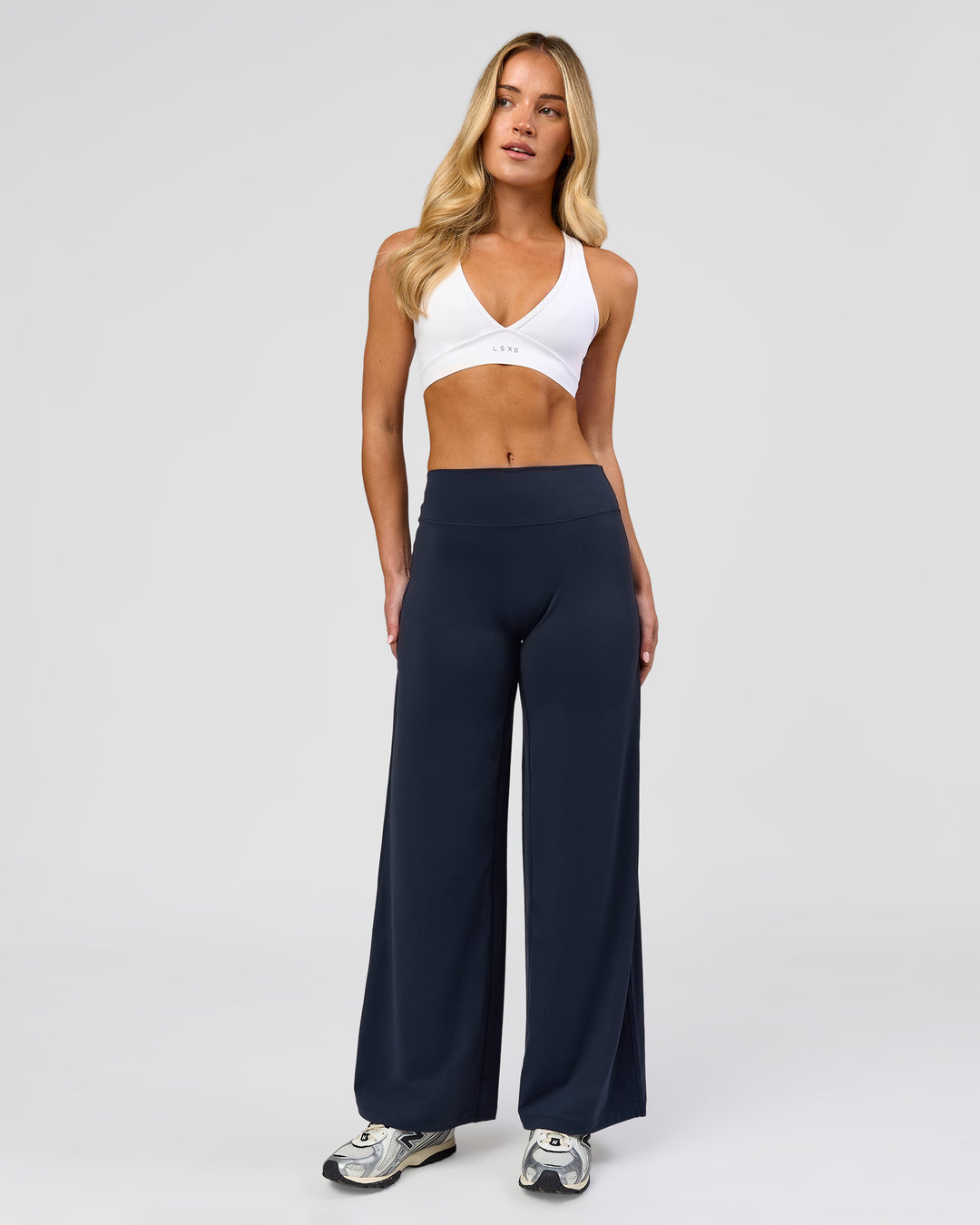 Woman wearing Elixir High-Rise Petite Pant - Midnight Navy | Model:Issy | Size:XS - view 1