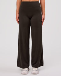 Woman wearing Elixir High-Rise Petite Pant - Ground Coffee | Model:Issy | Size:XS | Thumbnail Index: 0