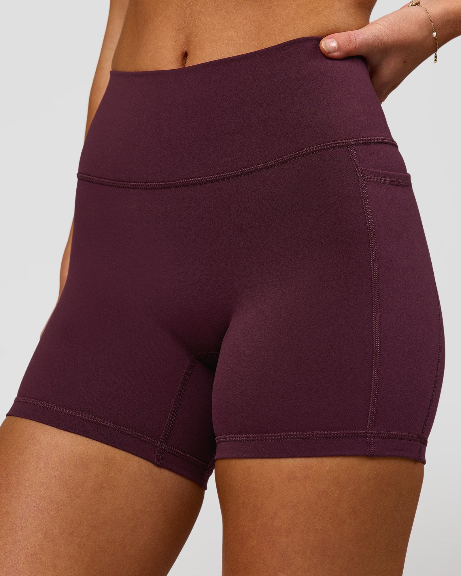 Woman wearing Fusion High-Rise 4" Short Pockets - Cherry Lacquer | Model:Issy | Size:XS