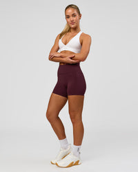Woman wearing Fusion High-Rise 4" Short Pockets - Cherry Lacquer | Model:Issy | Size:XS | Thumbnail Index: 1