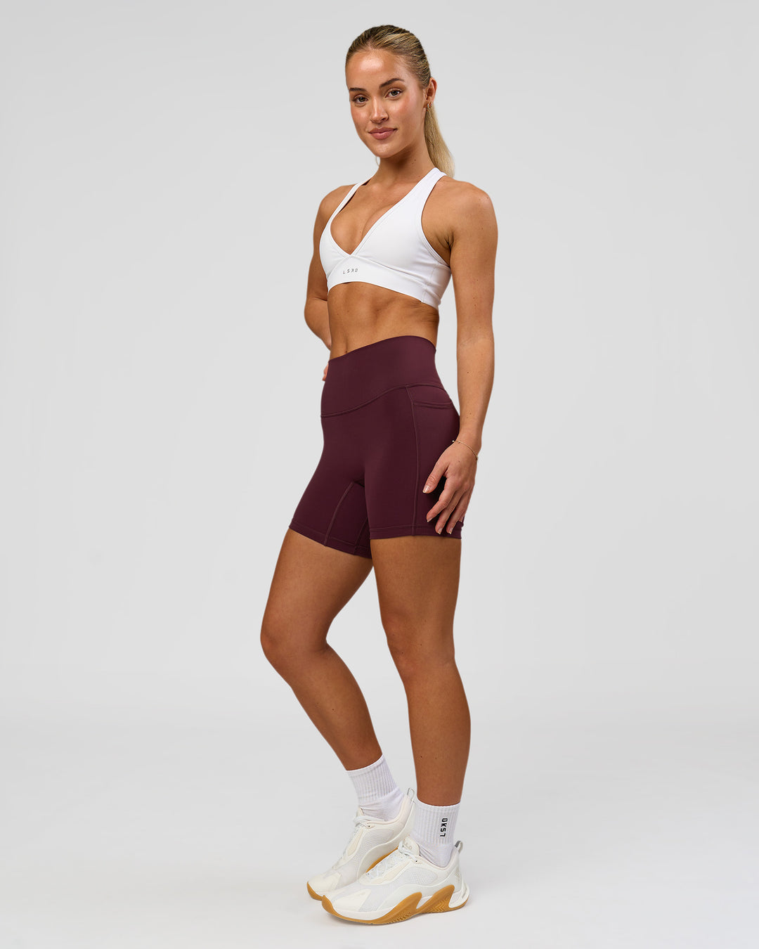 Woman wearing Fusion High-Rise 6" Short Pockets - Cherry Lacquer | Model:Issy | Size:XS - view 1