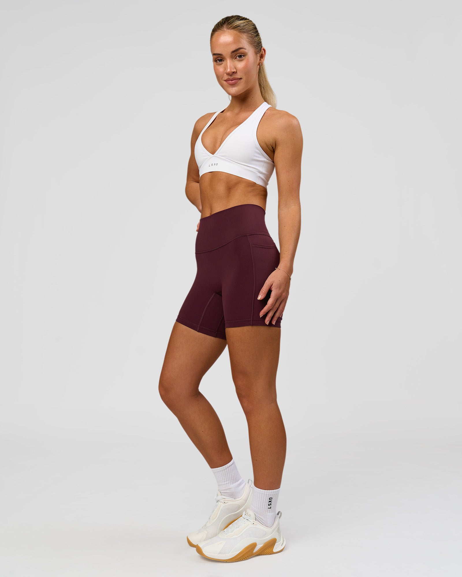 Woman wearing Fusion High-Rise 6" Short Pockets - Cherry Lacquer | Model:Issy | Size:XS