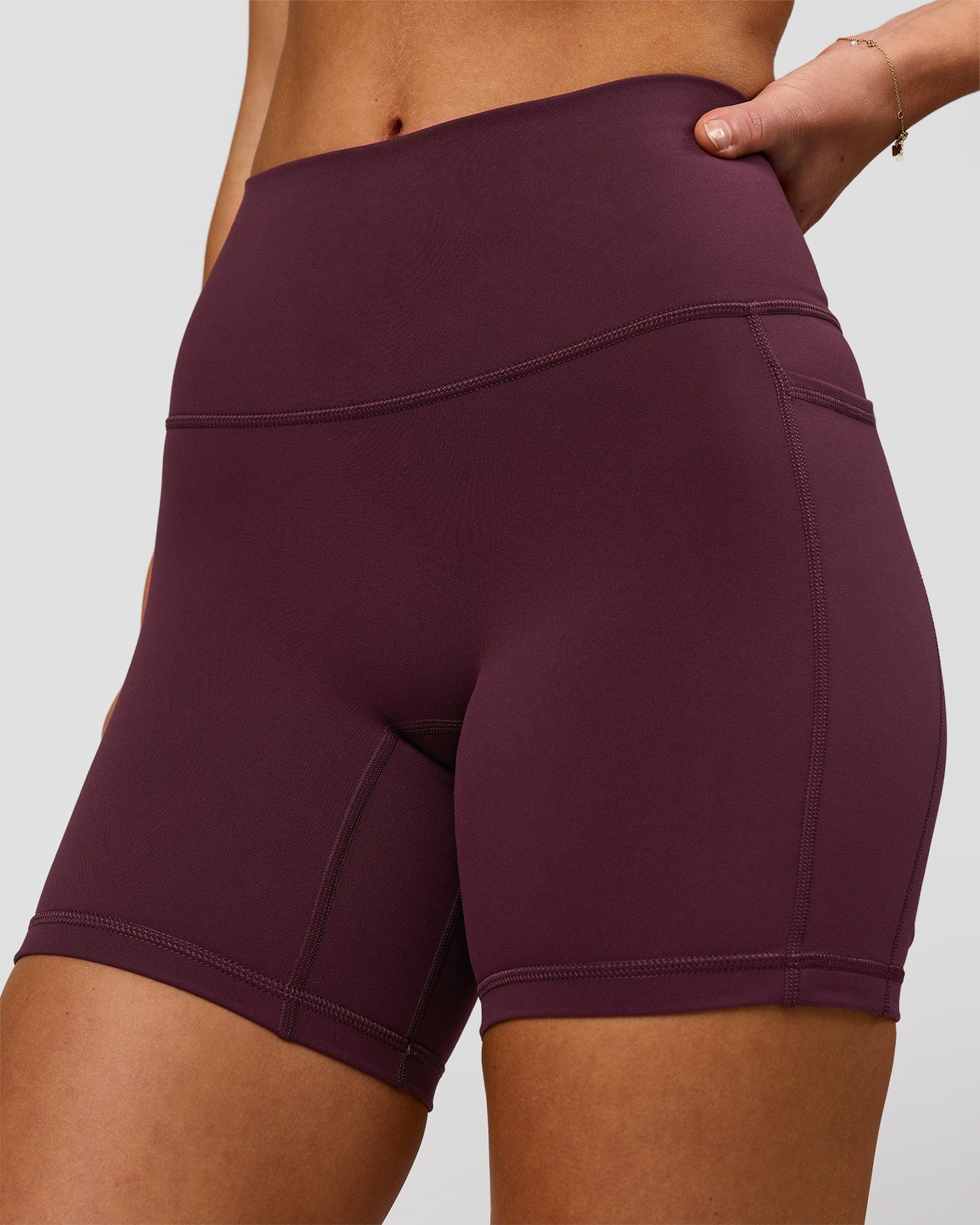 Woman wearing Fusion High-Rise 6" Short Pockets - Cherry Lacquer | Model:Issy | Size:XS