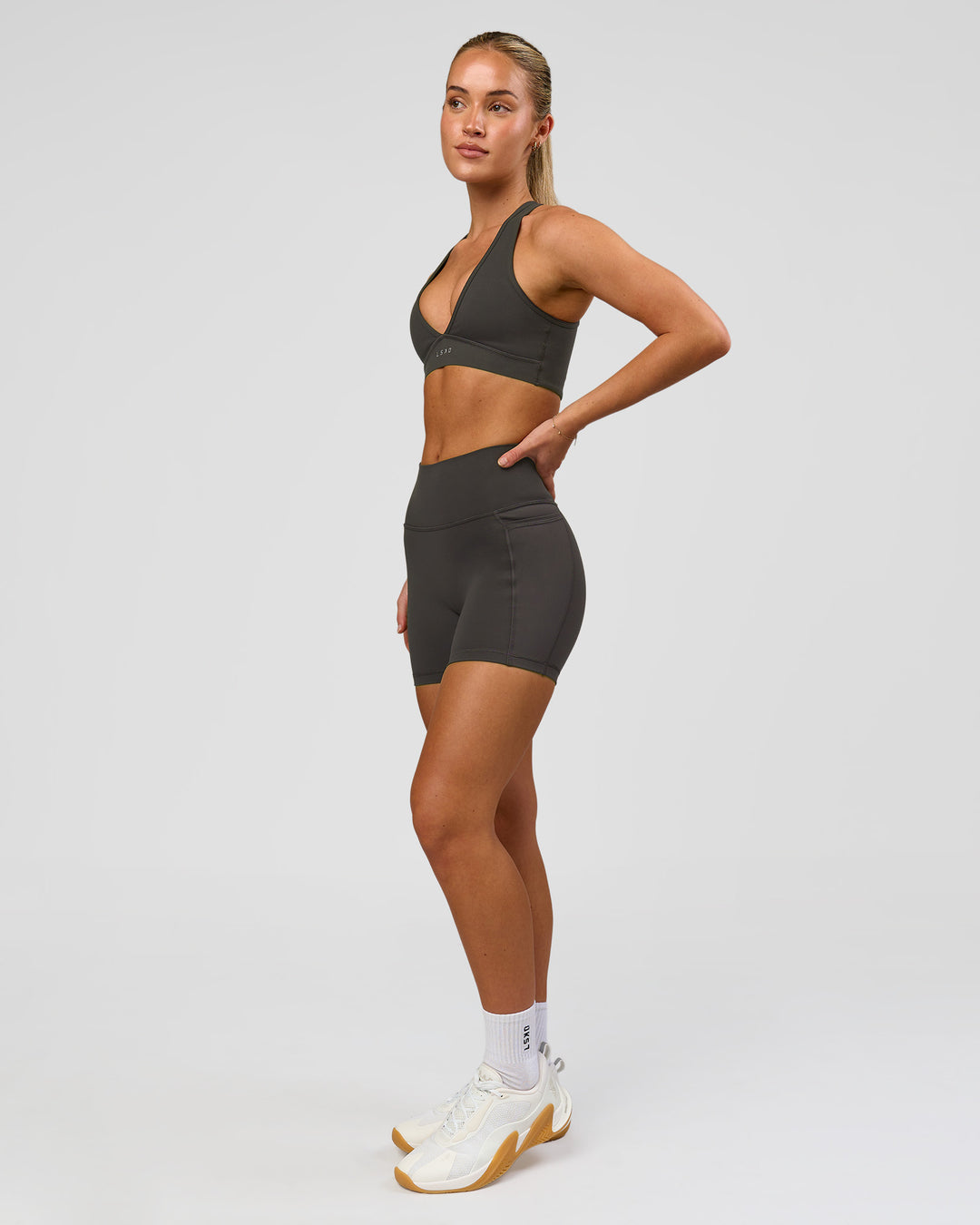 Woman wearing Fusion Ultra High-Rise 4" Short Pockets - Onyx | Model:Issy | Size:XS - view 9
