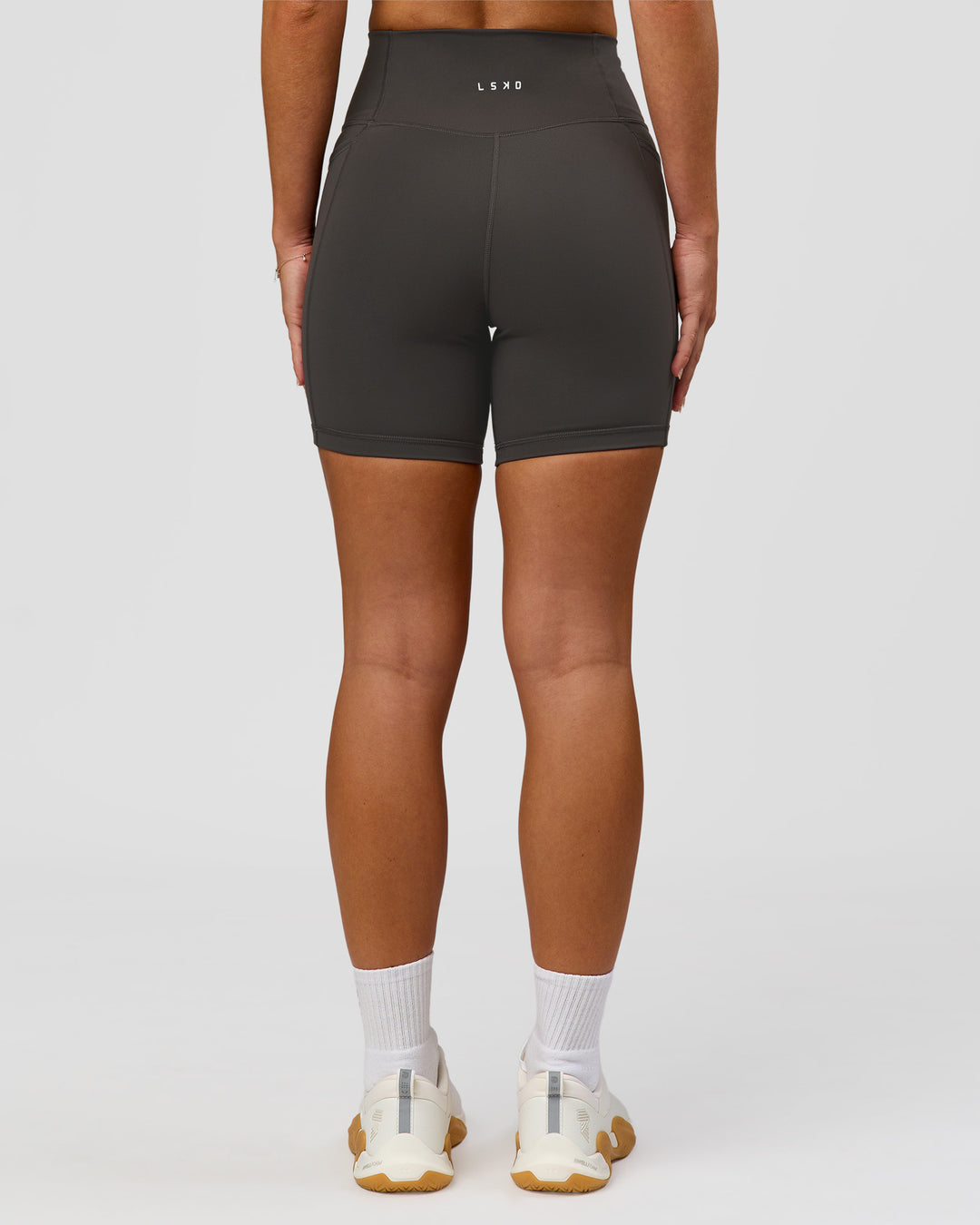 Woman wearing Fusion Ultra High-Rise 6" Short Pockets - Onyx | Model:Issy | Size:XS - view 4